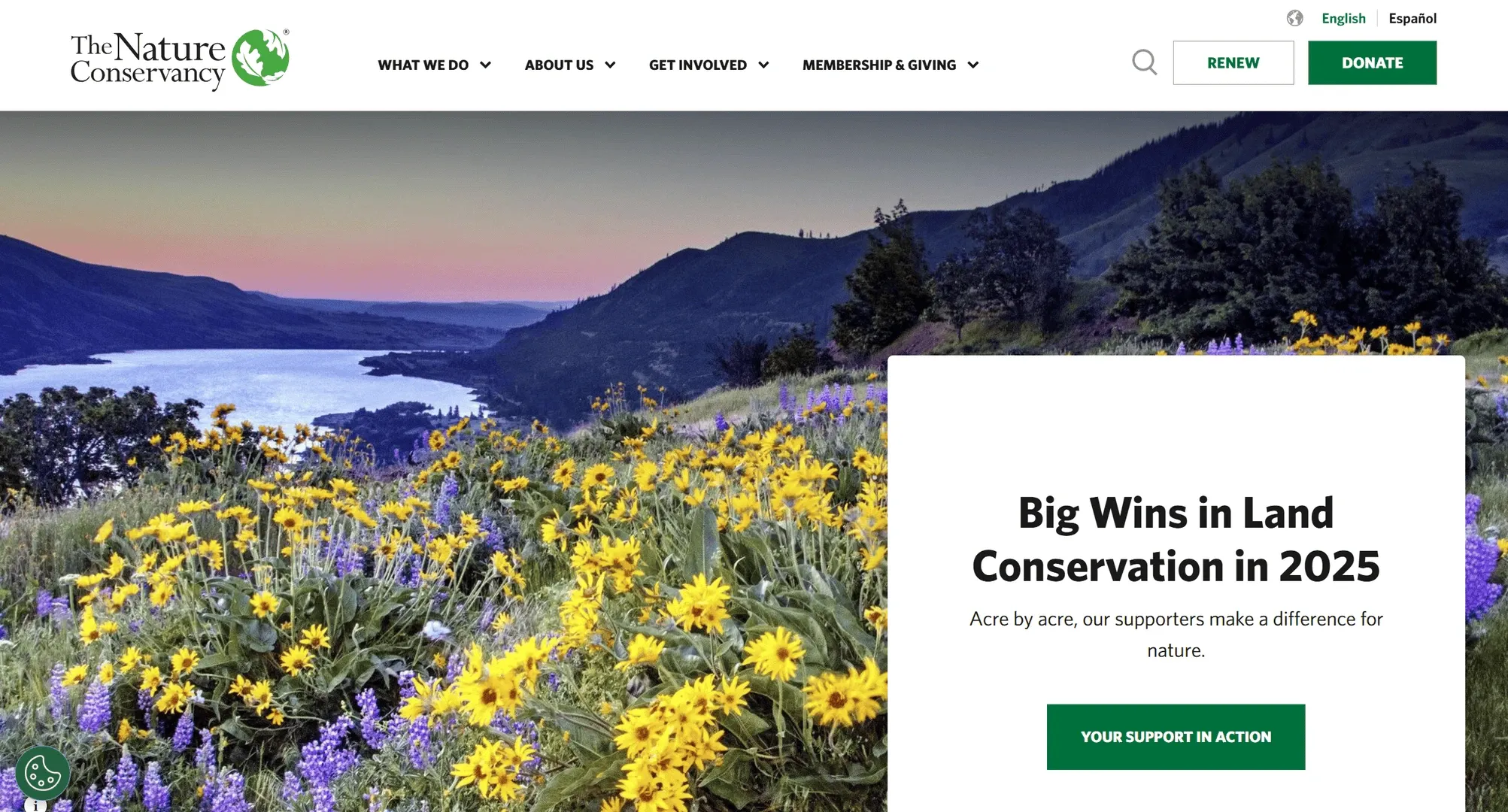 The Nature Conservancy homepage, a landscape photograph with a single feature card and a language switcher above