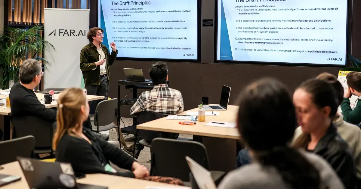 A researcher presenting draft principles on AI generalisation and robustness to a room of attendees at a FAR.AI workshop